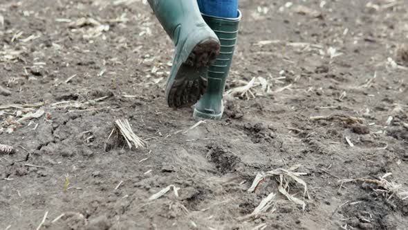 Farmer Worker Goes Home After Harvesting End of the Working Day Feet in Rubber Boots Agriculture