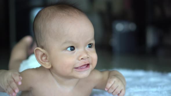 Happy portrait baby boy playing alone