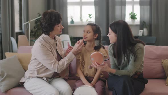 Applying Make-Up To Pretty Little Girl