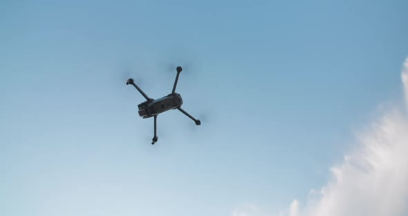 Takeoff Drone Flies on Bright Blue Sky Background. Modern Technologies for Shooting Photos and