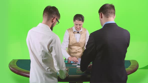 Men Playing Poker at the Table, the Dealer Deals the Cards and the Chips. Green Screen. Slow Motion