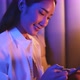Young Asian beautiful woman enjoy using smartphone in bedroom at night time. - VideoHive Item for Sale