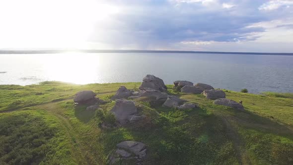 Aerial view of Huge stones (rocks) in a vast field by the lake 05