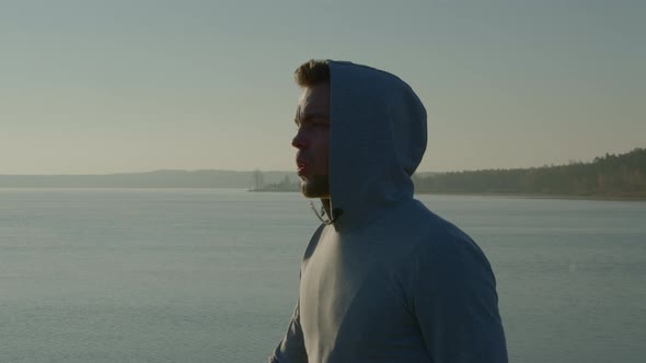 Young Man Is Walking Near Lake