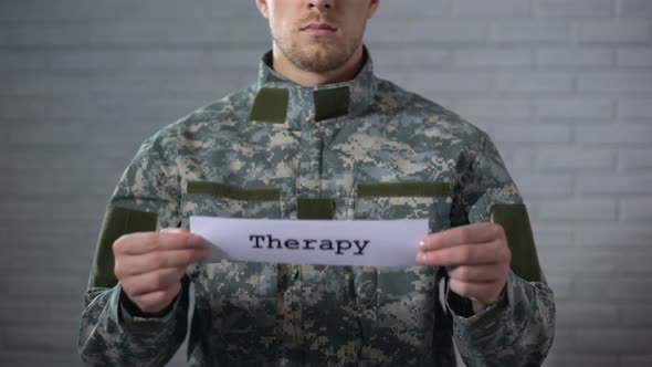 Therapy Word Written on Sign in Hands of Male Soldier, Medical Assistance