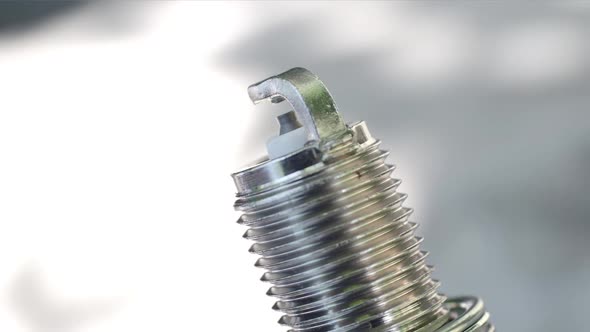 Close-up View of a New Spark Plug. Rotation