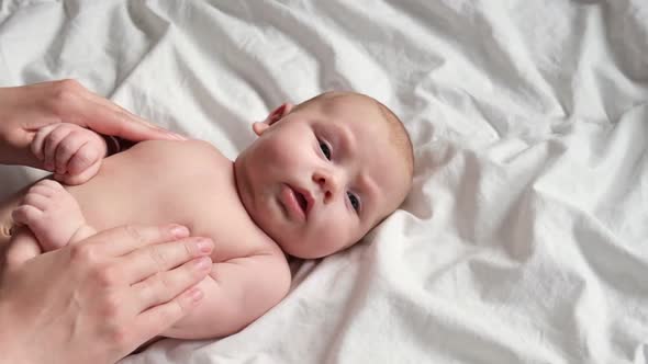 Mother Massaging Little Baby