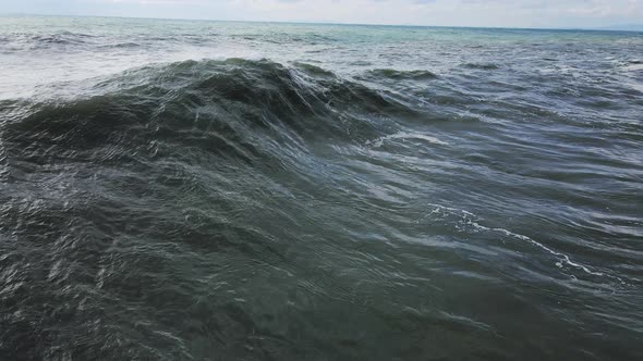 Powerful Waves Forming Breaking on the Shore and Splashing with White Foam