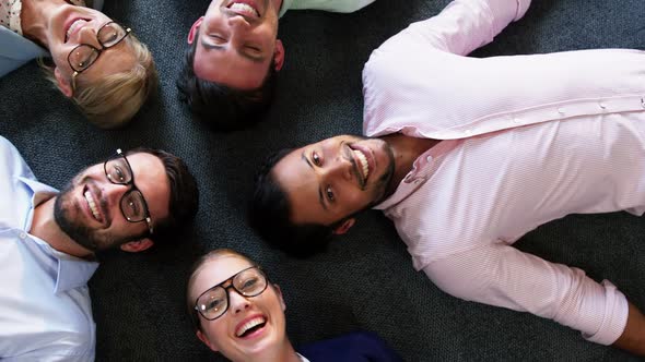 Portrait of businesspeople lying on the floor