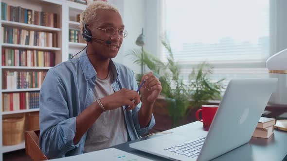 Young African American Business Man Discusses Company Affairs Through Headset