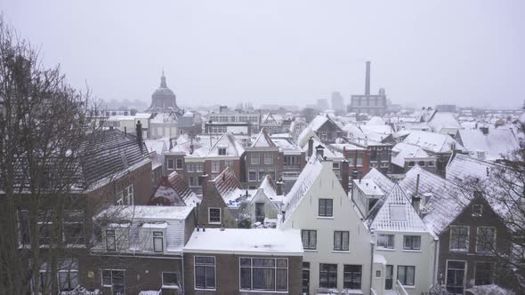 View over Leiden city buildings covered in winter snow, Netherlands