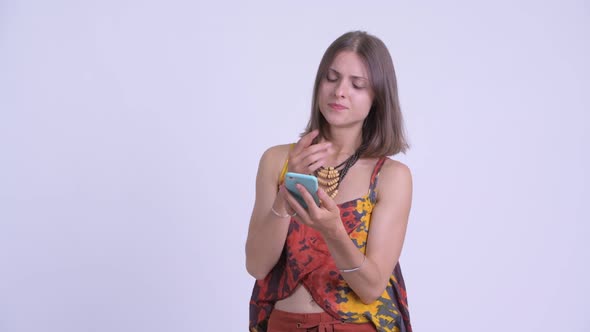 Happy Young Beautiful Hipster Woman Thinking While Using Phone