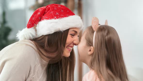 Closeup Excited Happy Mommy and Funny Child Relaxing Together Having Fun at Xmas Decoration