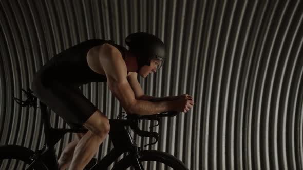 Professional Triathlete Rides a Cutting Bike Pro Cyclist Rides in a Tunnel Athlete Training for Race