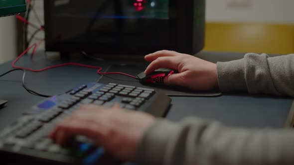 Close Up Hands Shot of Man Player Typing on RGB Keyboard