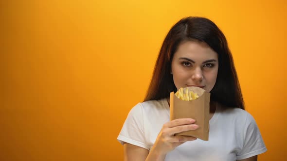 Smiling Girl Showing French Fries to Camera Recommending Tasty Fast Food