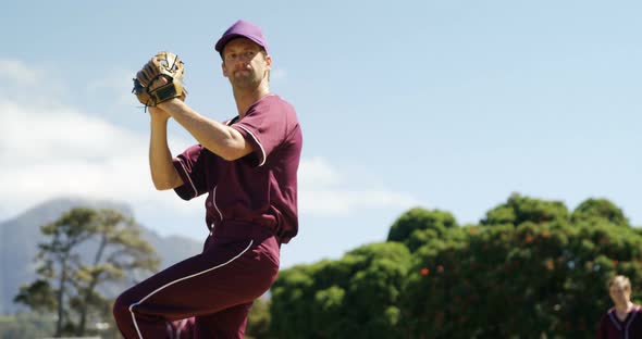 Baseball players pitching ball during practice session