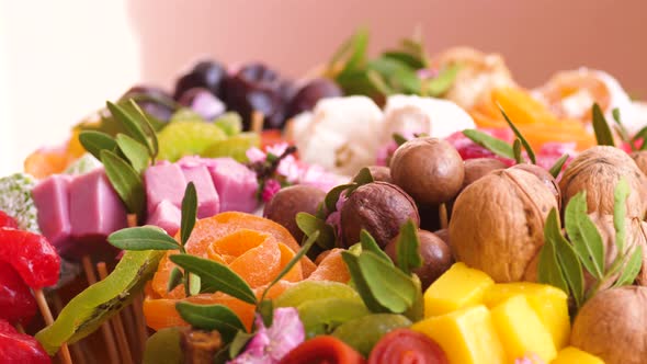 Close-up of a sweet bouquet of nuts, marmalade, prunes, dried fruits, marshmallows, Turkish delight 