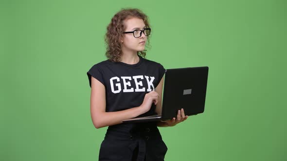 Young Beautiful Nerd Woman Thinking While Using Laptop