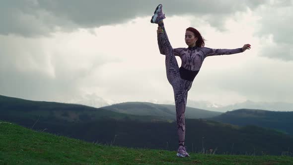 Athletic Woman Stretching Against Stunning Mountain Landscape