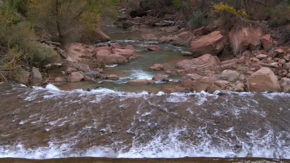 Water cascading down stream through red rocks