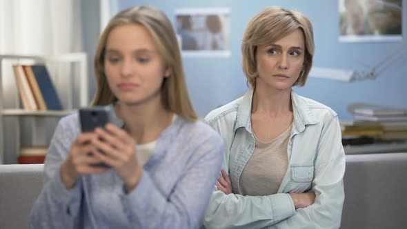 Daughter With Smartphone in Hands Ignoring Her Mom, Indifference, Puberty Age