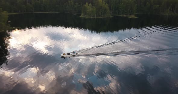 A boat moving through a glassy lake in finland