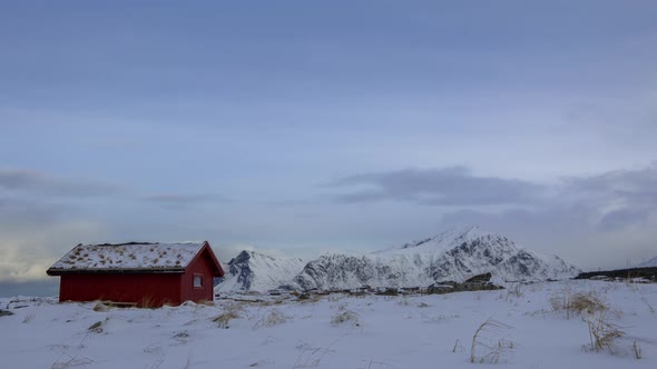 Clouds over the Winter Mountains and a Grass Roof