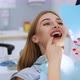 A Beautiful Woman Patient Shows Teeth in the Mirror to the Dentist - VideoHive Item for Sale
