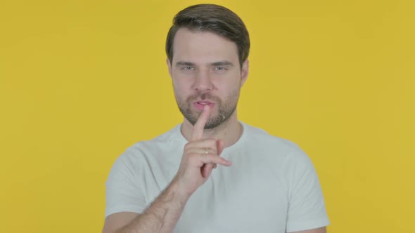 Young Man with Finger on Lips, Silence Yellow Screen