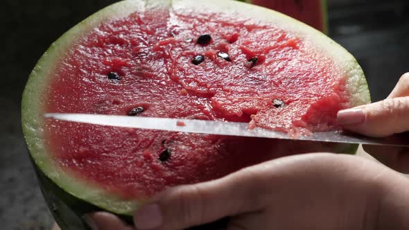 Woman Cut Ripe Red Watermelon with Knife