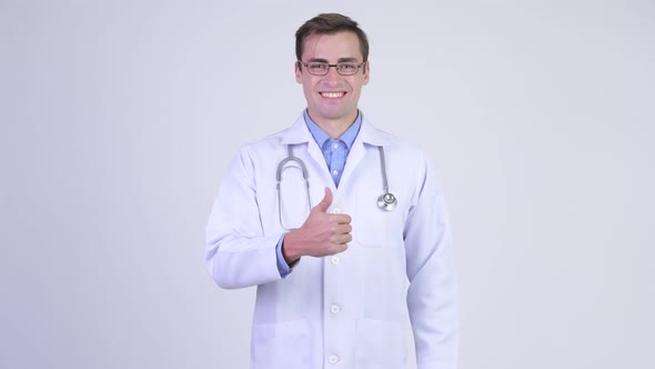 Young Happy Handsome Man Doctor Giving Thumbs Up