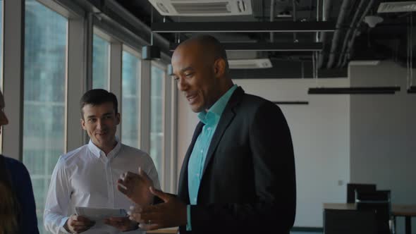 Boss and Employees Starting Work with Boxed Documents in New Office