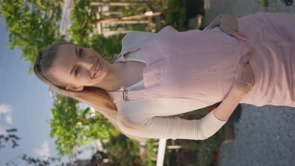 Female Seller Looking Into the Camera in Garden Centre