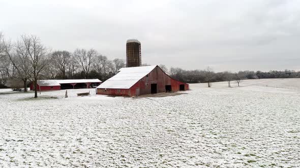 Low Flying Drone Shot of Red Hay Barn in the Snow Tennessee