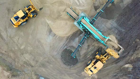 Sand mining industry. Bulldozer machine. Crawler bulldozering at sand mine. Mining machinery working
