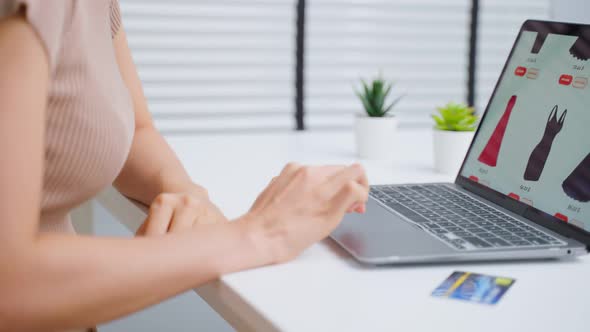 Asian young woman use laptop computer for shopping product sell online.