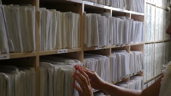 Female Hands Sorting Folders in Drawer for Papers