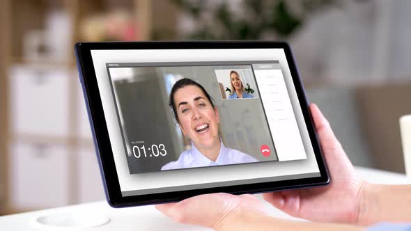 Woman Having Video Call on Tablet Computer at Home 