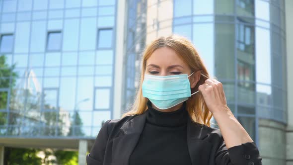 Caucasian Woman Removes a Medical Mask. End of Quarantine