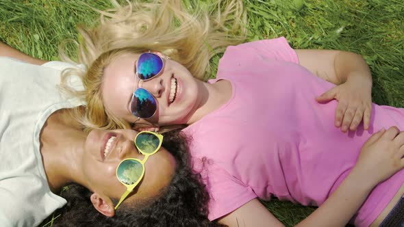 Two Happy Girls Best Friends Hanging Out on Grass in Park, Enjoying Weekend