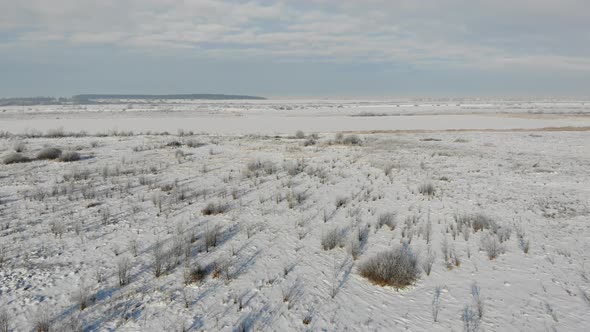 Flyover Above of Snow Covered Steppe. Sunny Day. Beautiful Winter Landscape