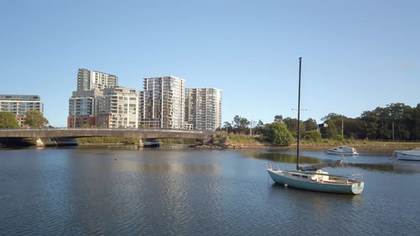 View of Sydney suburb with lake or river and a bridge with suburban waterfront apartments and highwa