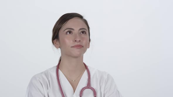 Woman doctor looks up in thought and nods her head