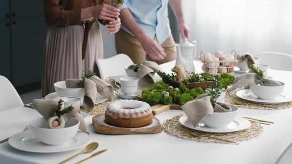 Caucasian couple preparing  table for easter dinner. Shot with RED helium camera in 8K.