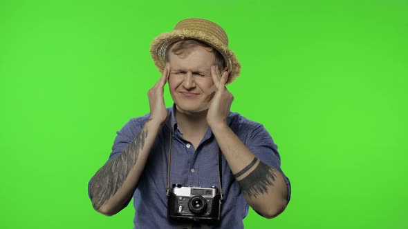 Portrait of Man Tourist Photographer Having Headache. Chroma Key