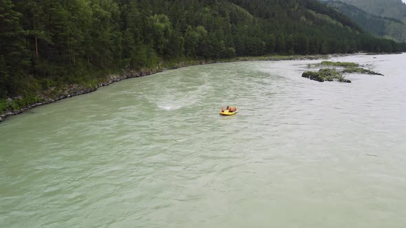 Sports Recreation on a Yellow Inflatable Boat in the Middle of the River