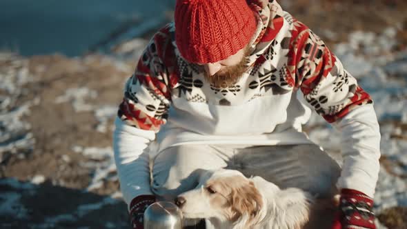 Man Hugs His Pet Dog in Winter Frozen Lake Happy Smiling Guy Playing with Border Collie Outdoors