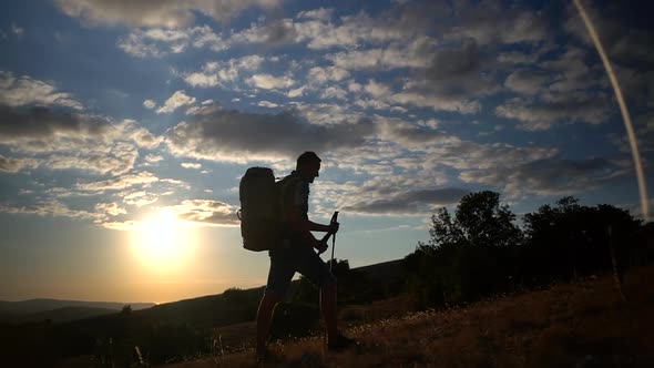 Travel Mountain Hike Silhouette of Man Mountain Hike Travel Climbing a Hill in Rays of Sunset