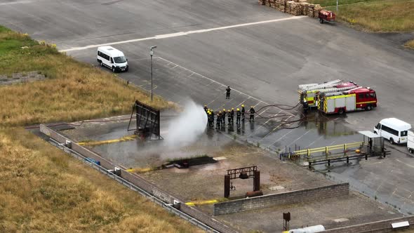 Firefighters Undergoing Training in a Mock Fire Response Emergency